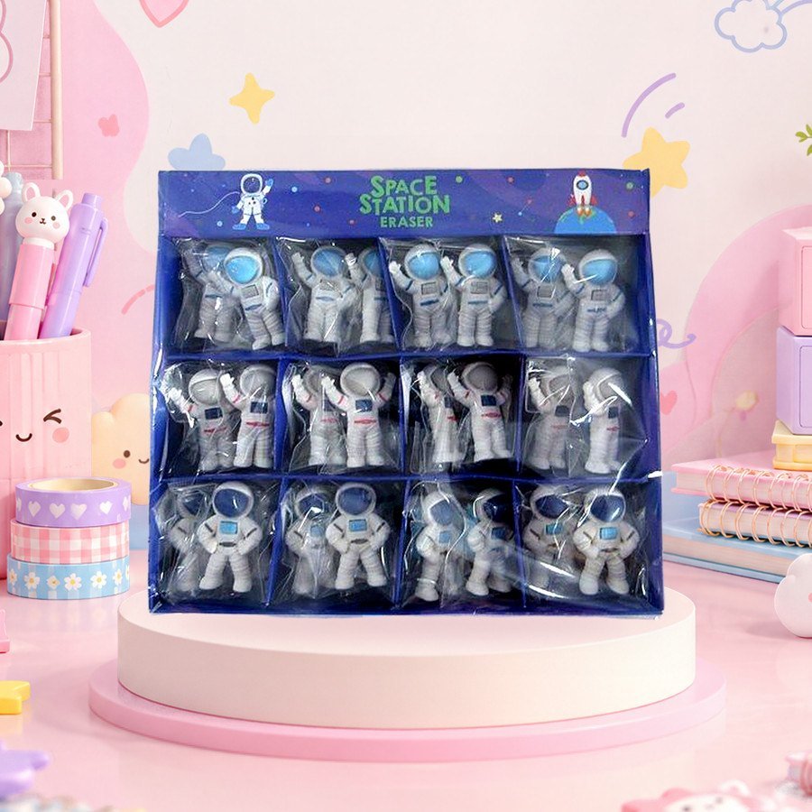 Spaceman Eraser: spaceman erasers in a display tray, on a pink kawaii desk — wholesale kawaii erasers from Tirth Enterprise
